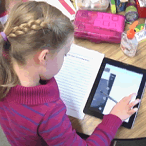 Student using video on a tablet to do homework